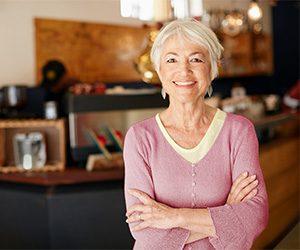 woman crossing arms and smiling at camera